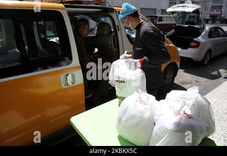 Des chefs palestiniens portant des masques protecteurs préparent des repas pour les personnes qui ont été mises en quarantaine, une précaution contre la propagation de la coronavirus (COVID-19), dans un restaurant de la ville de Gaza, sur 2 avril 2020 (photo de Majdi Fathi/NurPhoto) Banque D'Images