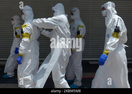 Les travailleurs de la santé portant des vêtements protecteurs se promo vers deux immeubles à Kuala Lumpur, au 8 avril 2020, après avoir été encorsés en raison d'un certain nombre de cas de personnes atteintes du nouveau coronavirus COVID-19 dans les locaux. (Photo de Zahim Mohd/NurPhoto) Banque D'Images