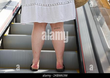 Section basse de la femme debout sur l'escalier roulant, Paris, France Banque D'Images