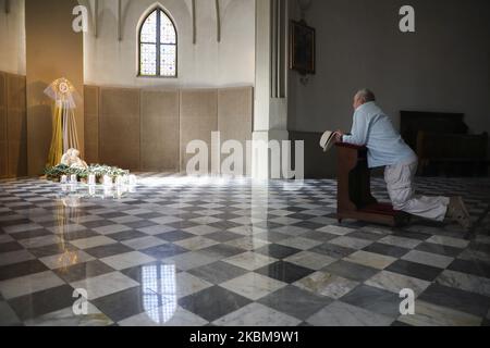 Un homme prie par la tombe du Christ le samedi Saint à l'intérieur de l'église Saint-Joseph pendant la propagation du coronavirus. Cracovie, Pologne, le 11th avril 2020. Une sculpture de Jésus-Christ a été réalisée par un artiste polonais Wincenty Kucma. (Photo de Beata Zawrzel/NurPhoto) Banque D'Images