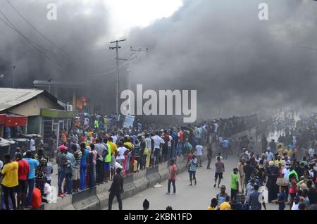 Des foules se rassemblent sur les lieux de l'incendie, ignorant les règles de distanciation sociale, à la station-service de la Nigerian National Petroleum Corporation (NNPC) située le long de College Road dans la région d'Ogba à Lagos, sur 27 avril 2020. (Photo par Olukayode Jaiyeola/NurPhoto) Banque D'Images