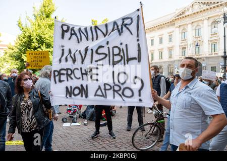 Les vendeurs de rue protestent devant le Palazzo Marino avec des panneaux et des bannières contre les mesures de la phase 2 du confinement du coronavirus qui ne leur permettent pas de reprendre leurs activités le 18th mai 2020 à Milan, Italie. (Photo par Alessandro Bremec/NurPhoto) Banque D'Images