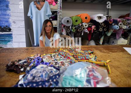 Eleonora à l'intérieur de la boutique de tailleur de sa mère Tiziana, attend de porter l'une des créations qui font parler à l'atelier: Le trikini, un bikini avec les mêmes motifs décoratifs que le masque protecteur, créé pendant la crise de santé déclenchée par le coronavirus. Falconara Marittima, Italie, 15 mai 2020. (Photo par Andrea Savorani Neri/NurPhoto) Banque D'Images