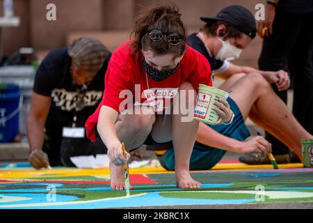 Dix-sept artistes noirs et leurs assistants peignent une peinture murale Black Lives Matter sur la rue Plumb, sur les traces de l'hôtel de ville, jeudi, 18 juin 2020, à Cincinnati, Ohio, États-Unis. (Photo de Jason Whitman/NurPhoto) Banque D'Images