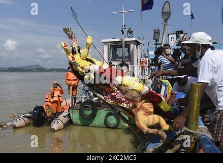 Les ouvriers municipaux portent une idole de la déesse hindoue Durga pour l'immersion dans les eaux de la rivière Brahmaputra pendant le dernier jour du festival Durga Puja à Guwahati, Inde sur 26 octobre 2020. Le dernier jour du festival s'appelle Vijay Dashmi, Vijaya signifiant « victoire » et Dashmi signifiant « dixième ». Durga Puja est largement célébrée dans les États indiens du Bengale occidental, Assam, Jharkhand, Orissa et Tripura et culmine dans l'immersion des idoles de la déesse hindoue Durga, qui symbolise la puissance et le triomphe du bien sur le mal dans la mythologie hindoue. (Photo de David Talukdar/NurPhoto) Banque D'Images