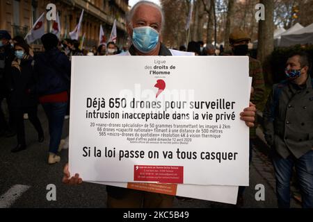 Un membre de la LDH (Human Rights League) tient une lecture de carton "déjà 650 drones pour nous regarder" plus de 5000 manifestants ont protesté une fois de plus contre le projet de loi appelé "loi sur la sécurité mondiale" promu par le président français Macron et sa majorité. Le projet de loi sur la "loi mondiale sur la sécurité" interdonnera également à quiconque de photographier ou de filmer des membres de la police s'il n'est pas bafoué : les transgresseurs pourraient être condamnés jusqu'à un an de prison et une amende de €45,000 ans. Le projet de loi prévoit également de généraliser la reconnaissance faciale dans les espaces publics comme en Chine.le défenseur français des droits, la Commission nationale française des droits de l'homme (administ Banque D'Images