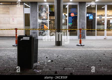 Les travailleurs tentent de réparer les lunettes brisées des portes de la gare centrale d'Eindhoven après les émeutes. La gare d'Eindhoven Centraal endommagée avec des fenêtres et des pierres cassées. Les conséquences de la manifestation anti-verrouillage ont perturbé le centre-ville d'Eindhoven aux pays-Bas. Le deuxième jour du strict coronavirus Covid-19 mesures de verrouillage avec un couvre-feu imposé entre 21:00 et 04:30 par le gouvernement néerlandais depuis 23 janvier 2021, afin de lutter contre la propagation de la pandémie et la nouvelle mutation. Des centaines de manifestants se sont affrontés avec la police dans un rassemblement contre les nouvelles règles. TH Banque D'Images