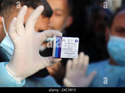 Un agent de santé palestinien porte une boîte de doses de vaccin Spoutnik V de marque russe provenant des Émirats arabes Unis, à l'arrivée d'une charge de camions dans la bande de Gaza via le passage de Rafah avec l'Égypte, sur 21 février 2021. - Environ 20 000 doses de vaccin contre le coronavirus en provenance des Émirats arabes Unis sont arrivées aujourd'hui à Gaza, une livraison aurait été orchestrée par un rival du président palestinien Mahmud Abbas trois mois avant la tenue des élections palestiniennes. (Photo de Majdi Fathi/NurPhoto) Banque D'Images