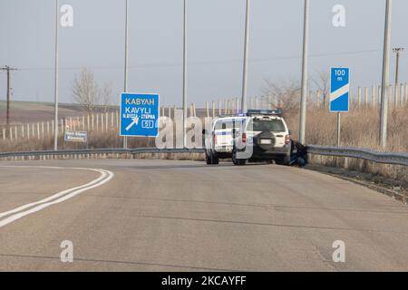 Des voitures de police et des agents de police sont vus en possession de 2 sans-papiers, un d'Afghanistan et un d'Afrique, qui ont franchi illégalement les frontières de la Turquie, sur l'autoroute près de la ville d'Orestiada dans la région d'Evros, Thrace en Grèce. La rivière Evros ou Martisa ou Meric est la frontière extérieure du Sud-est de l'UE et de la zone Schengen. Les demandeurs d'asile sont capturés le long des frontières grecques turques alors qu'ils tentent d'entrer en Grèce et dans l'Union européenne. La police hellénique et les forces de Frontex patrouillent la frontière et capturent quotidiennement, emprisonnent ou arrêtent des migrants, des réfugiés et des passeurs sur le grec - Banque D'Images