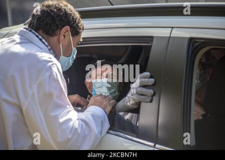 Une infirmière bénévole du service de santé de la Principauté des Asturies vaccine un homme âgé assis dans sa voiture avec une dose de Pfizer. Sur 25 mars 2021 à Noreña, Asturies, Espagne. (Photo d'Alvaro Fuente/NurPhoto) Banque D'Images