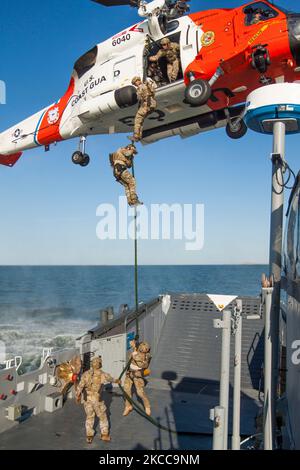 L'équipe d'intervention de la sécurité maritime de la Garde côtière des États-Unis fait un cordage rapide à partir d'un hélicoptère MH-60T Jay Hawk. Banque D'Images