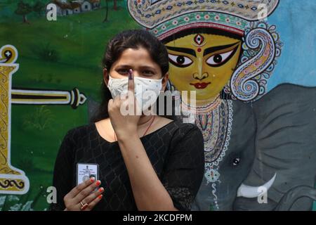 Une femme portant un masque montre son doigt inké après avoir fait son vote au bureau de vote, lors de la phase 7th des élections de l'Assemblée du Bengale occidental à Kolkata, en Inde, le 26 avril 2021. La phase 7th des élections de l'Assemblée du Bengale occidental 2021 précède la pandémie du coronavirus Covid-19. (Photo de Debajyoti Chakraborty/NurPhoto) Banque D'Images