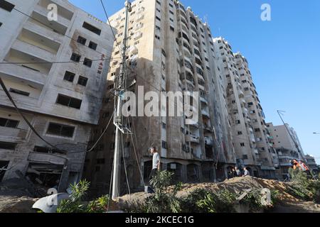 Les Palestiniens inspectent les dégâts dans un quartier résidentiel de la ville de Gaza au début de 12 mai 2021, à la suite de frappes aériennes israéliennes continues sur le territoire géré par le Hamas pendant la nuit. - Les raids aériens israéliens dans la bande de Gaza ont frappé les foyers de membres de haut rang du groupe militant du Hamas, ont déclaré les militaires mercredi, et le quartier général de la police du territoire a également été ciblé. (Photo de Majdi Fathi/NurPhoto) Banque D'Images