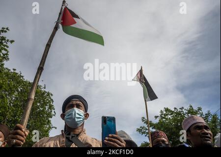 Les manifestants portent des drapeaux palestiniens tout en participant à une manifestation de solidarité à Palu, dans la province centrale de Sulawesi, en Indonésie, à 21 mai 2021. L'action de solidarité qui a été suivie par les membres de l'organisation musulmane est une forme de soutien et de défense des Palestiniens pour les attaques sionistes et les atrocités israéliennes. Gaza est à l'origine de la crise humanitaire dans la région. (Photo de Basri Marzuki/NurPhoto) Banque D'Images