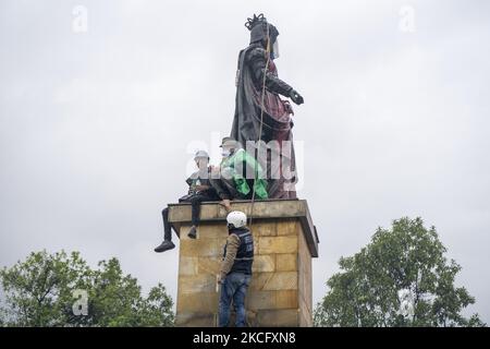 Misak se dresse devant des policiers alors qu'elle proteste à côté de la statue de la reine Isabel d'Espagne sur 09 juin 2021 à Bogota, en Colombie. Une autre journée de manifestations à Bogota, en Colombie, aujourd'hui en compagnie de Misak indigène qui prétendait faire tomber la statue de ''Isabel le catholique'' et le conquérant Cristobal Colon d'Amérique. (Photo de David Rodriguez/NurPhoto) Banque D'Images