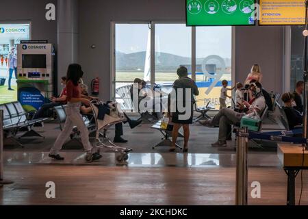 Personnes dans la salle d'attente devant les portes de l'aéroport d'Athènes. Passagers avec masques comme vu à l'aéroport international d'Athènes ATH LGAV Eleftherios Venizelos dans la capitale grecque. Les passagers arrivant utilisent l'aéroport pour se rendre aux îles et aux villes continentales éloignées avec des tests négatifs ou un passeport de vaccination vert. La Grèce est une destination de voyage populaire avec des plages célèbres et une industrie touristique fortement développée, avec une longue saison touristique car elle est située dans la partie sud de l'Europe dans les eaux méditerranéennes. La Grèce tente de stimuler son tourisme et de donner des privilèges à va Banque D'Images