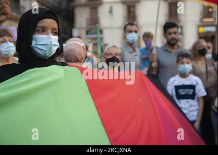 Une fille afghane détient un drapeau afghan pendant la concentration qui va faire connaître Barcelone de la situation en Afghanistan, à Barcelone, Espagne, sur 18 août 2021. (Photo de Charlie Perez/NurPhoto) Banque D'Images