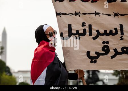 Un manifestant tient une bannière lors d’une manifestation contre la première visite de Naftali Bennett à la Maison Blanche en tant que Premier ministre d’Israël. Les manifestants exigent que les États-Unis sanctionnent Israël pour ses attaques continues contre les Palestiniens, y compris le meurtre d'enfants, et le retrait continu des Palestiniens de leurs foyers. Au début du rassemblement, les agents des services secrets ont informé les manifestants qu'ils ne pouvaient pas protester à Lafayette Park et ont mis en place une ligne de police autour du périmètre. L'ordre est très inhabituel; le Service secret permet régulièrement des manifestations de milliers de personnes dans le parc. (Tél Banque D'Images