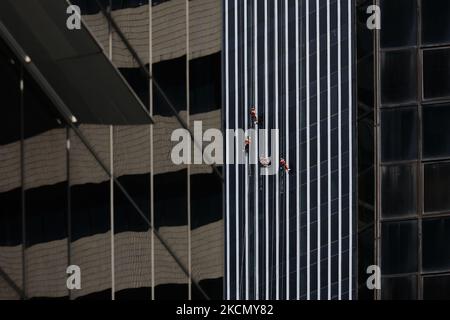 Les travailleurs portant un harnais de sécurité nettoient la façade d'un chantier de construction en cours à 20 septembre 2021, à Singapour. (Photo de Suhaimi Abdullah/NurPhoto) Banque D'Images