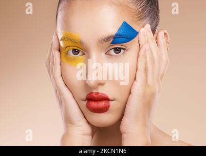 Beauté, clown et portrait d'une femme avec maquillage, peinture du visage ou art du visage pour l'expression de soi en studio. Esthétique, créative et ludique Banque D'Images