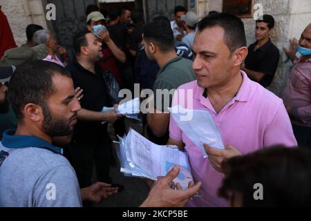 Des hommes palestiniens se réunissent pour demander des permis de travail en Israël, au camp de réfugiés de Jabalia, dans le nord de la bande de Gaza, sur 6 octobre 2021. (Photo de Majdi Fathi/NurPhoto) Banque D'Images