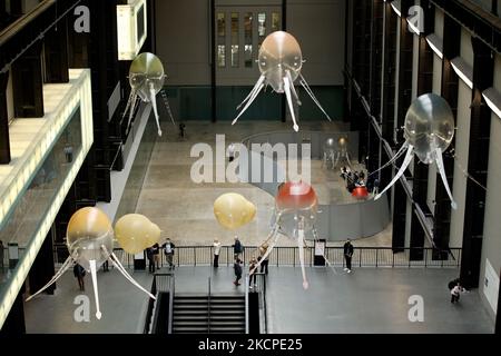 Des « aérobies » propulsés par rotor et remplis d'hélium, formant l'artiste Anicka Yi « amoureux du monde » flottent autour du hall turbine de la galerie d'art moderne Tate lors du dévoilement de l'œuvre, la dernière de la série de la Commission Hyundai, à Londres, en Angleterre, sur 11 octobre 2021. Les machines flottantes sont destinées à « inciter les spectateurs à réfléchir à de nouvelles façons dont les machines pourraient habiter le monde » et à former la sixième commission Hyundai des œuvres annuelles créées par des artistes spécialement pour le turbine Hall. L'installation sera exécutée jusqu'à 16 janvier l'année prochaine. (Photo de David Cliff/NurPhoto) Banque D'Images