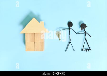 Propriétaire d'un nouveau concept de couple. Maison en bois avec clé. Banque D'Images