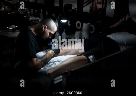 Un tatouage artiste a vu travailler sur un client lors de l'EXPO Tattoo d'Athènes 5th à 23 octobre 2021 à Athènes, Grèce. 140 meilleurs tatoueurs grecs ont participé à l'EXPO Tattoo d'Athènes 5th et ils ont également fait des tatouages aux personnes qui étaient intéressées. (Photo de Nikolas Kokovovlis/NurPhoto) Banque D'Images