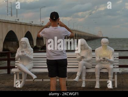 Un homme prend des photos devant l'installation de sculpture 'absorbé par la lumière' conçue par le Gala britannique May Lucas et réalisée par le sculpteur berlinois Karoline Hinz, à Progreso. Mardi, 23 novembre 2021, à Progreso, Yucatan, Mexique. (Photo par Artur Widak/NurPhoto) Banque D'Images