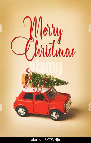 Voiture de jouet rétro rouge portant un arbre de Noël sur fond vintage avec texte Banque D'Images