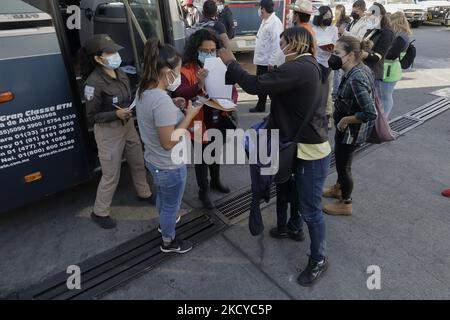 Des travailleurs de l'Institut national des migrations et de la Commission des droits de l'homme gardent des membres de la caravane de migrants dans le parking de la Casa Peregrino, Mexico, Avant d'embarquer dans plusieurs bus qui les emmènent au nord du Mexique où ils poursuivront le traitement de leurs visas humanitaires après des négociations et des accords avec le gouvernement mexicain. (Photo de Gerardo Vieyra/NurPhoto) Banque D'Images