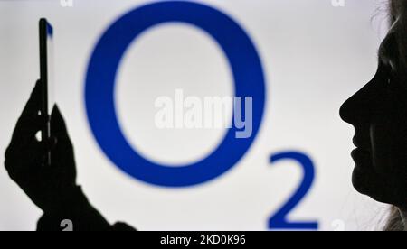 Image d'une femme tenant un téléphone portable devant le logo O2 affiché sur un écran d'ordinateur. Mardi, 12 janvier 2021, à Edmonton, en Alberta, Canada. (Photo par Artur Widak/NurPhoto) Banque D'Images