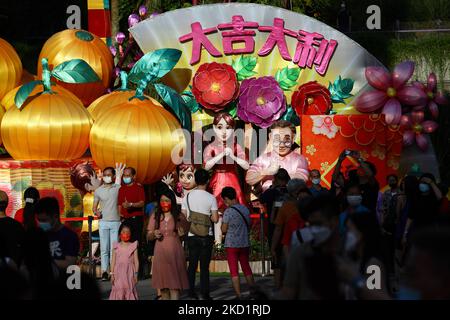 Les personnes sous masque protecteur prennent des photos avec une lanterne pendant le festival de la rivière Hongbao, qui a lieu dans le cadre de la célébration du nouvel an chinois dans les jardins de la baie de 3 février 2022 à Singapour. (Photo de Suhaimi Abdullah/NurPhoto) Banque D'Images