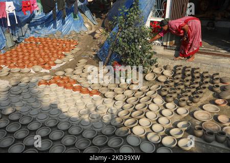 Une femelle potier arrange des ustensiles faits de boue d'argile pour sécher au soleil à Kumar Para (communauté de potters) dans la banlieue de Munshigonj de Dhaka, au Bangladesh sur 22 février 2022. (Photo de Kazi Salahuddin Razu/NurPhoto) Banque D'Images