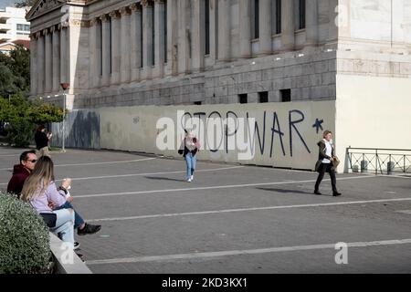 Les gens passent devant un graffiti qui écrit "STOP WAR" comme un signe de solidarité avec l'Ukraine dans le centre d'Athènes, Grèce sur 26 février 2022. (Photo de Nikolas Kokovovlis/NurPhoto) Banque D'Images