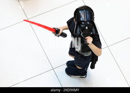 Un jeune fan s'habille comme le personnage de Darth Vader du film Star Wars et se prépare à s'assembler à Suntec City sur 14 mai 2022 à Singapour. 143 fans de Star Wars des communautés locales ont convergé dans le centre commercial pour établir le livre des records de Singapour pour le plus grand rassemblement de fans habillés comme les personnages de la franchise. (Photo de Suhaimi Abdullah/NurPhoto) Banque D'Images