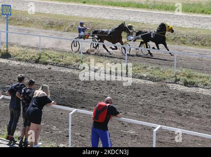 Les Ukrainiens regardent les cavaliers avec des chevaux pendant une saison d'ouverture d'été de horserace, dans le cadre de l'invasion de l'Ukraine par la Russie, à l'hippodrome d'Odesa, Ukraine le 25 juin 2022. (Photo par STR/NurPhoto) Banque D'Images