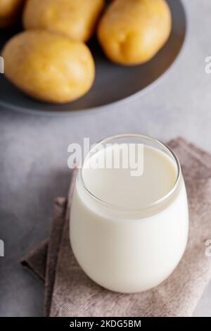 Lait de pomme de terre de remplacement dans un verre transparent. Produit de remplacement du lait à base de plantes et sans lactose. Concept de lait non laitier Banque D'Images