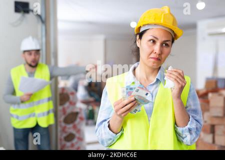 Une femme architecte pleure à cause d'un problème de salaire Banque D'Images