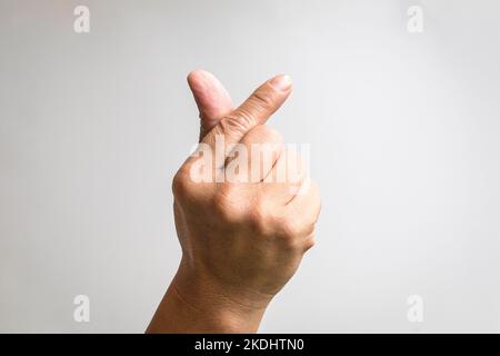 Symbole coréen de l'amour avec les doigts. Un doigt mâle représente une forme de coeur. Banque D'Images
