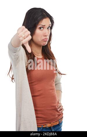 Faire clairement comprendre sa désapprobation. Portrait d'une jeune femme malheureuse montrant un pouce vers le bas en studio. Banque D'Images
