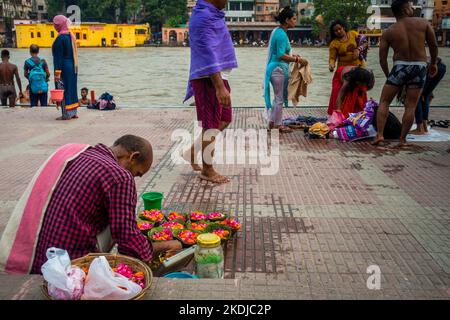 8 juillet 2022 Haridwar Inde. Un homme qui vend des fleurs colorées sur les rives ou les ghats de la rivière Ganges pour les rituels hindous. Banque D'Images