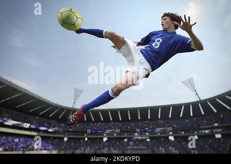 Un joueur de football frappe le ballon Banque D'Images