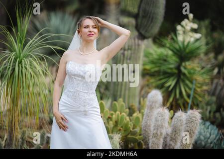 Mariée debout dans un jardin de Cactus Banque D'Images