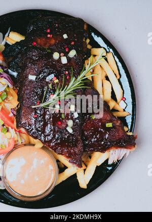 Frites, côtes grillées au romarin et au coleslaw. Nourriture savoureuse Banque D'Images