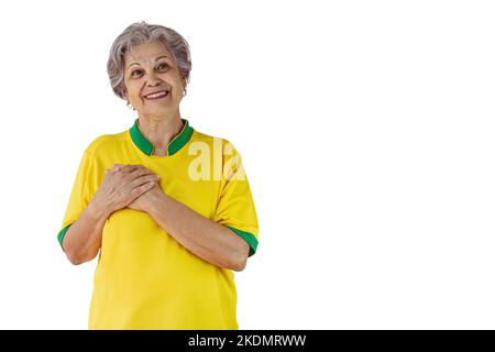 Femme mature avec maillot jaune de l'équipe de football isolé sur blanc. Fan de sport avec drapeau célébrant la coupe. Banque D'Images