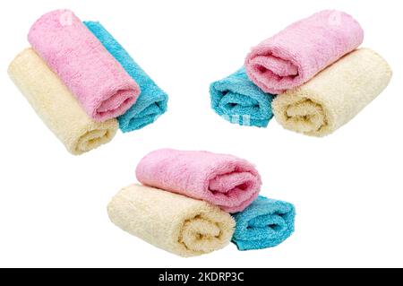 Trois rouleaux de serviettes propres de couleur pastel isolées sur fond blanc. Banque D'Images