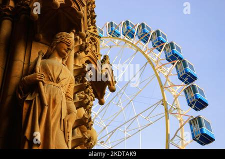 Grande roue de Noël en face de la cathédrale de Metz. Femme avec les yeux couverts statue sur la façade. Metz, France. Banque D'Images