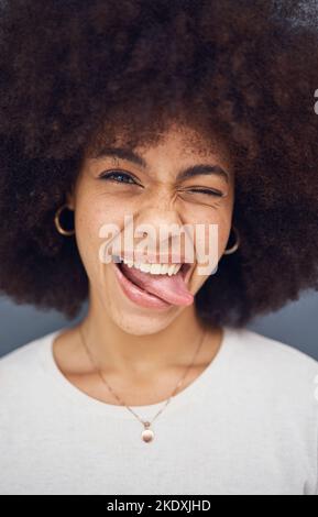 Drôle, la femme noire et avec la langue dehors heureux, sourire et le contenu avec bonheur, ridicule et blague. Afro-américaine femme, jeune fille et avec afro pour Banque D'Images