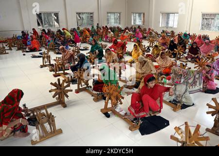 Les travailleurs font tourner le fil de coton pour fabriquer des vêtements de mousseline traditionnels dans un atelier à Narayanganj. Avec ses roues tournants en bois et ses métiers à tisser dessinés à la main, le Bangladesh ressuscite minutieusement un tissu autrefois porté par Marie-Antoinette et Jane Austen, mais longtemps considéré comme perdu à jamais dans l'histoire. -Aller avec 'Bangladesh-Fashion-Muslin'. Sur 8 novembre 2022 à Narayanganj, Dhaka, Bangladesh. Photo de Habibur Rahman/ABACAPRESS.COM Banque D'Images